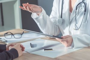 Person at a medical consultation with a doctor.