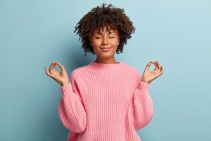 Black woman doing meditation.